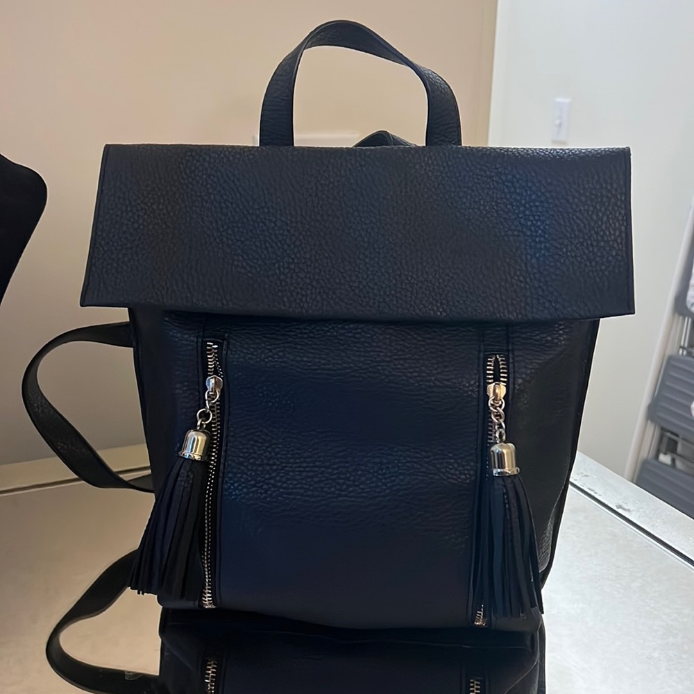 Express mini black backpack with gold hardware.